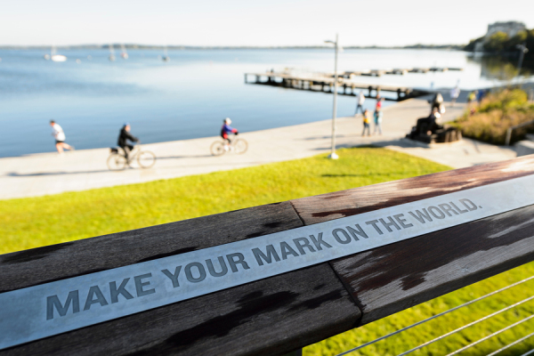 Alumni park sign that says 'make your mark on the world'
