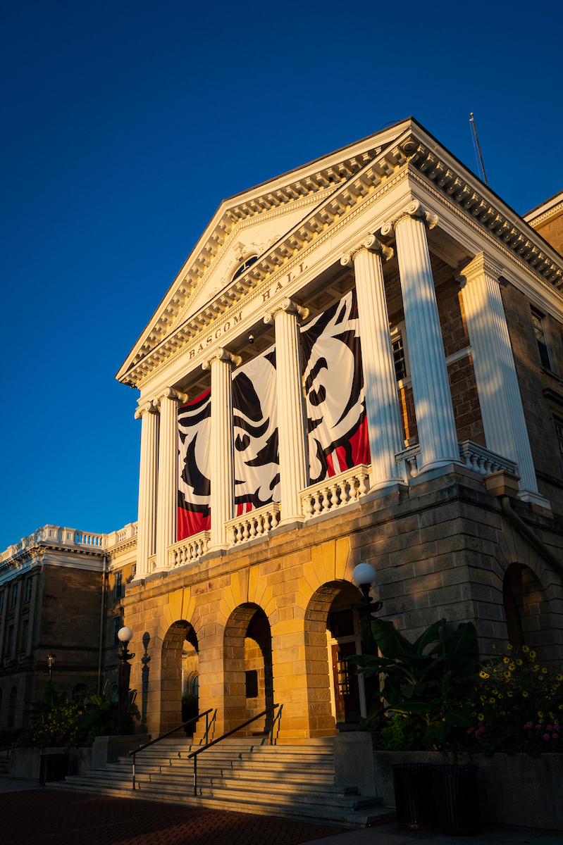 Bascom Hall, featuring Bucky Badger banners, during sunrise at the University of Wisconsin-Madison
