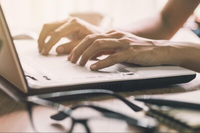A person typing on a keyboard.