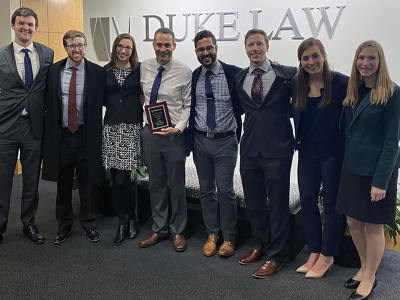UW Law students and their coaches with their LawMeets competition trophy