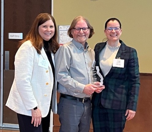 Erin McBride and Jay Tucker receiving the award
