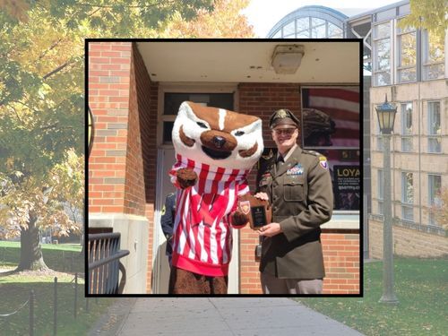 Bucky Badger and Fort McCoy (Wis.) Garrison Deputy Commander Lt. Col. Mike Corkum are shown Sept. 7, 2024, at the university campus in Madison, Wis., following an induction ceremony for the university's Badger Battalion Heritage Alumni Hall of Fame. Corku