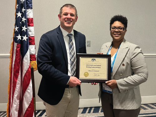 Tiffany Mitchell receives an award for winning the ABA Standing Committee on Armed Forces Law 2025 writing contest