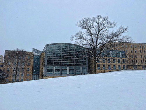 Law building with snow falling