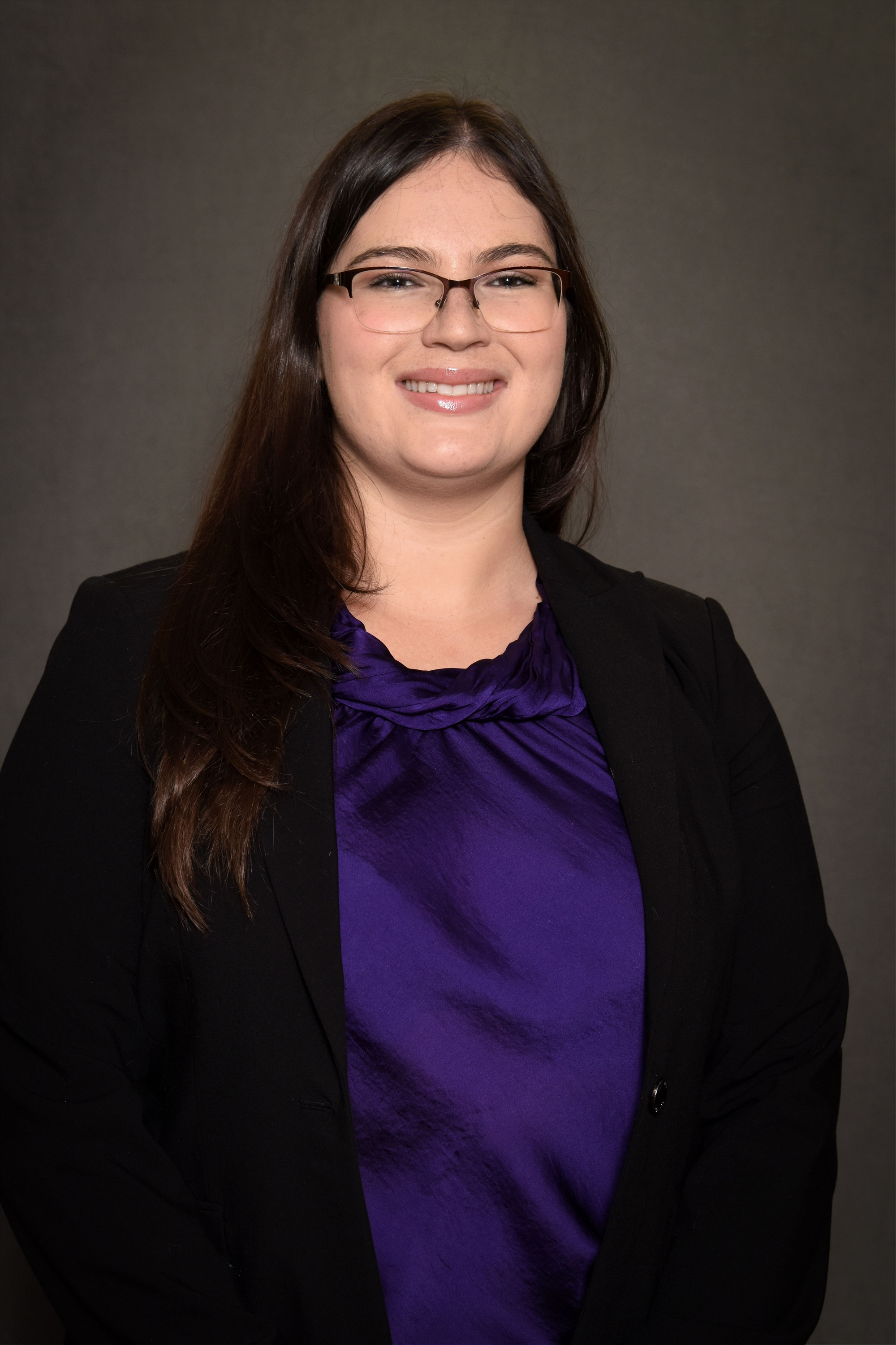 woman in purple blouse and black blazer