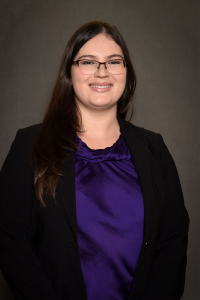 woman in purple blouse and black blazer
