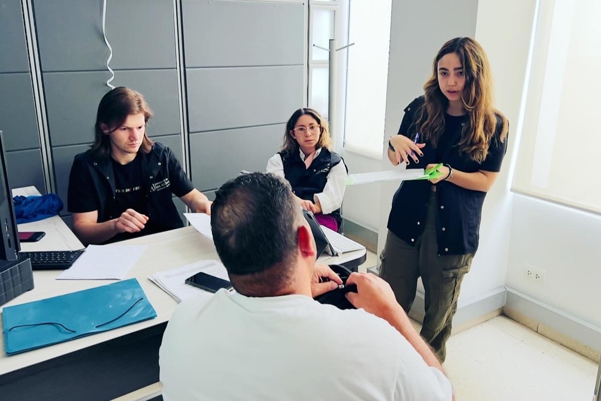 photo of students talking with people in a secure room