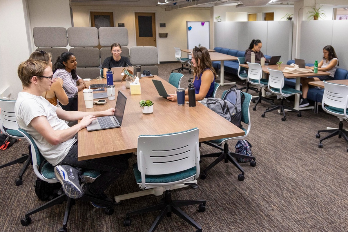 photo of students sitting at a long table