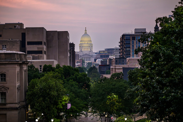photo of WI capitol building in the distance during sunrise