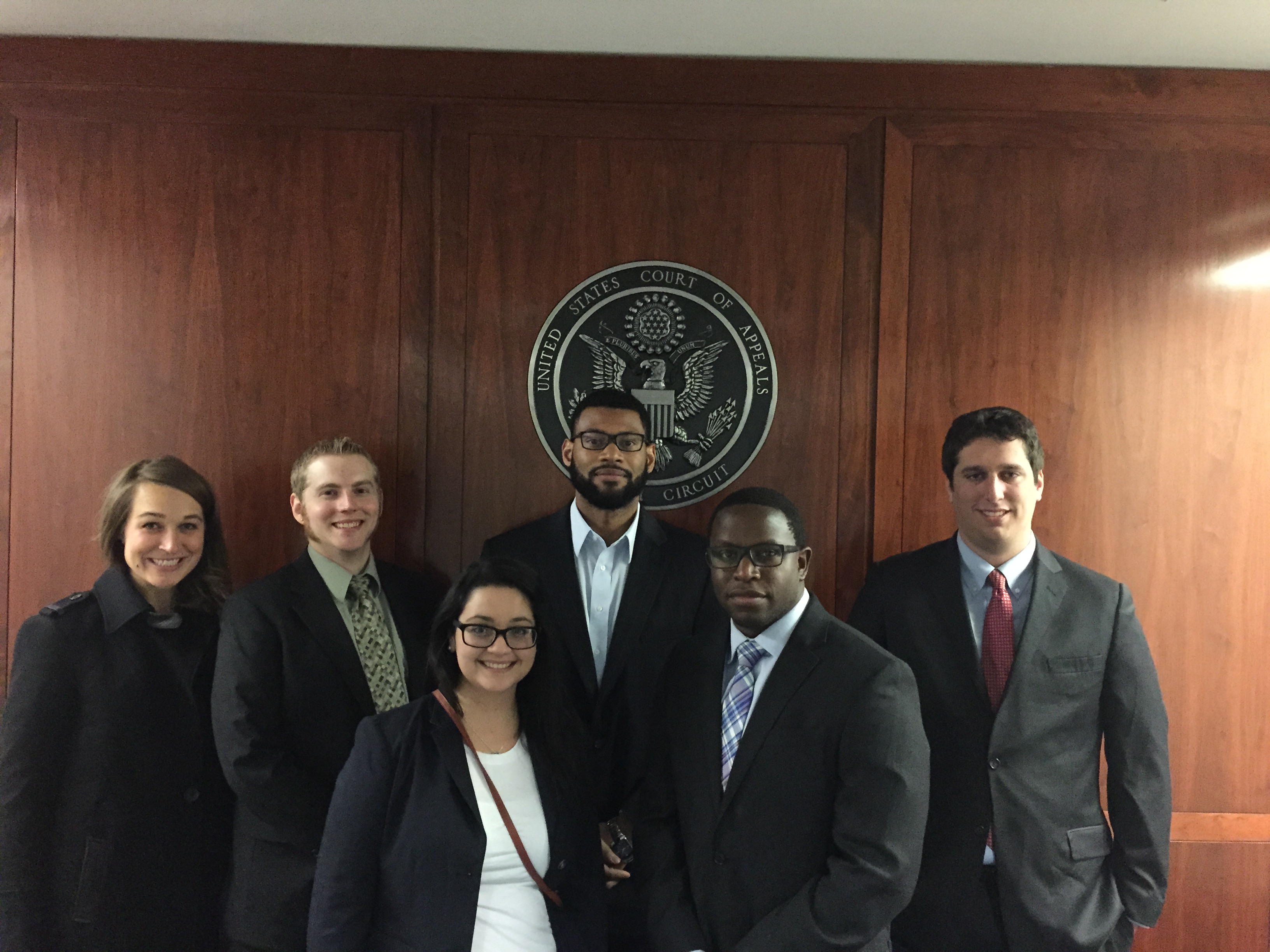 students and mentors in a courtroom